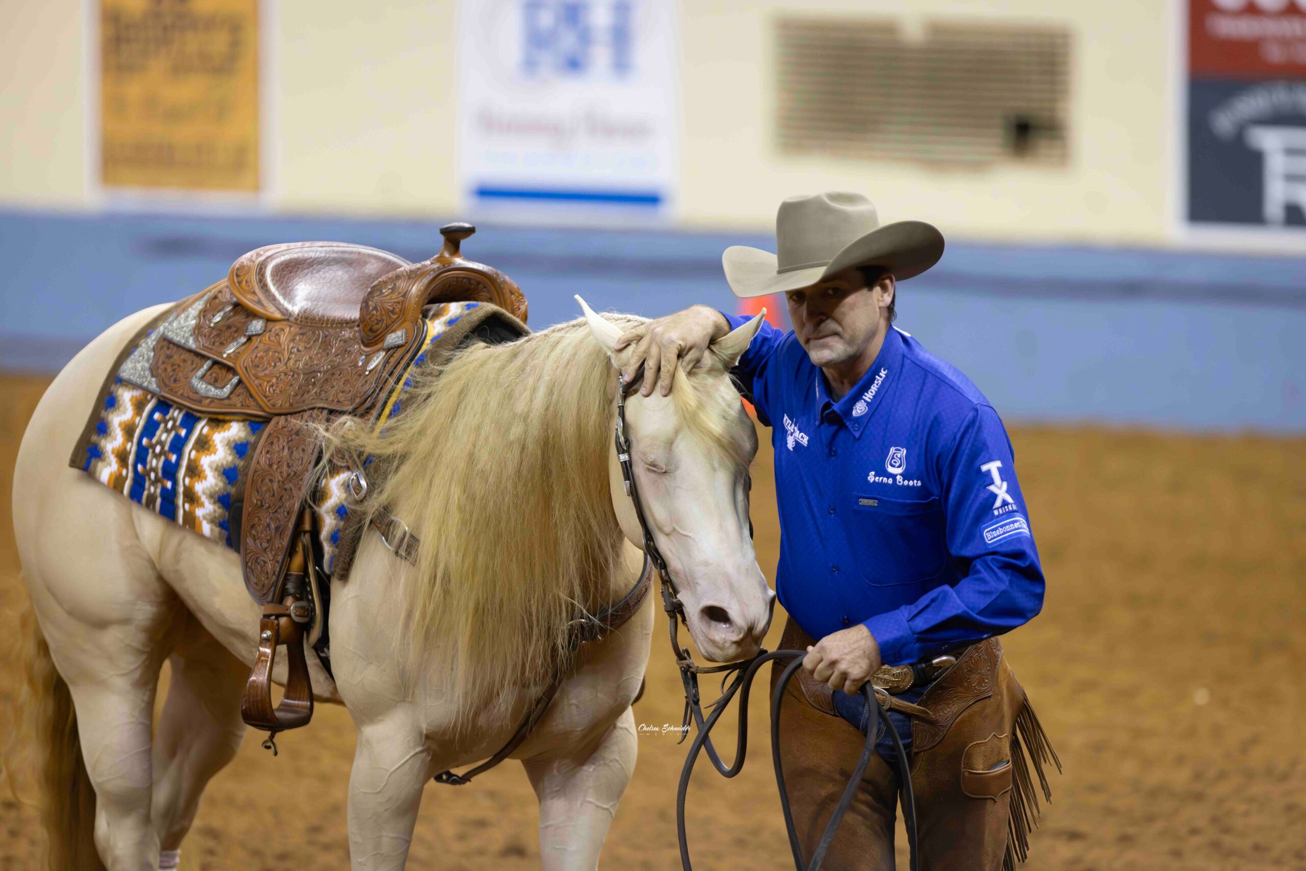 Brian Bell praising his horse after his first reining futurity on the mare Crystalized Whizkey.